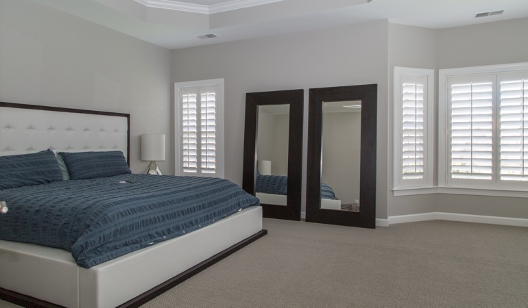 Polywood shutters in a minimalist bedroom in New Brunswick.